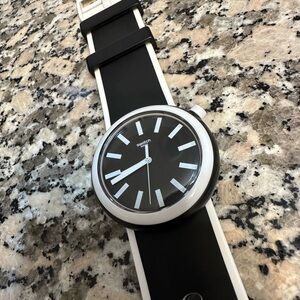 Women’s black and white Swatch Watch.